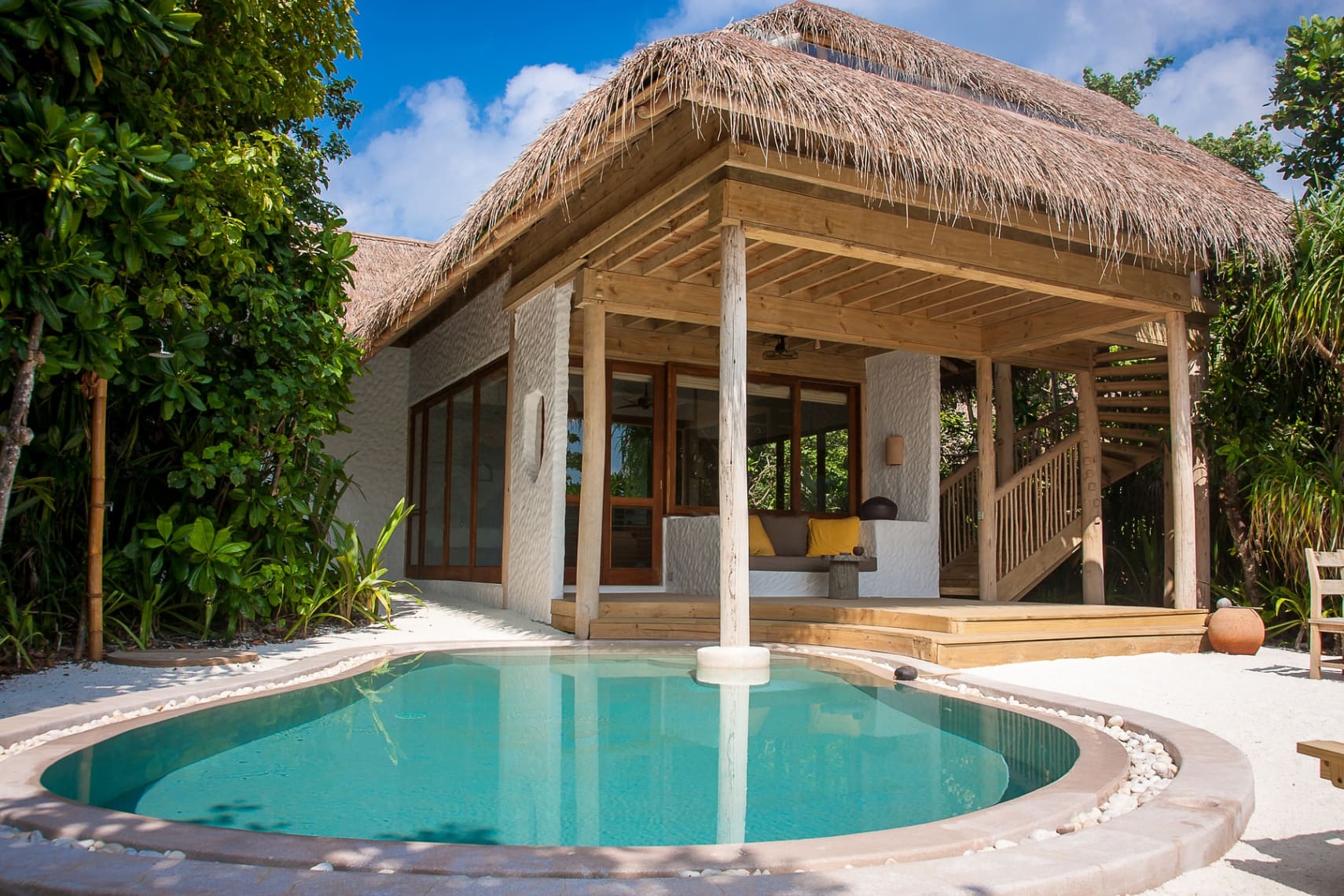 An overwater saltwater plunge pool above a turquoise Maldivian lagoon